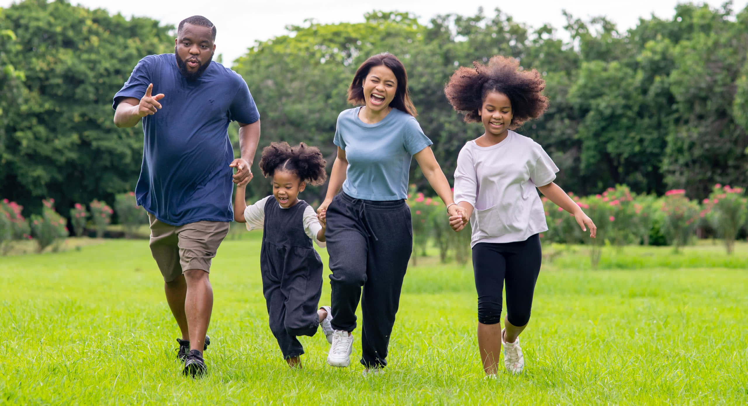Family running together in an open field